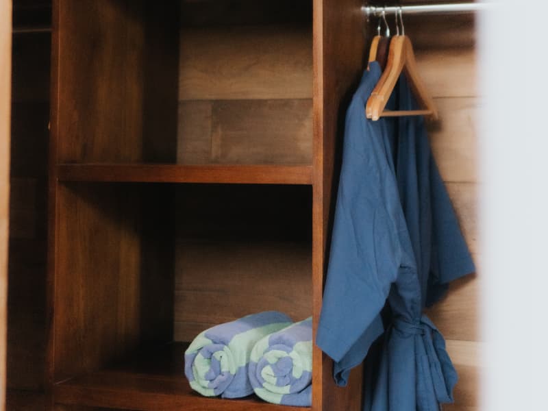 Balinese Hand-Carved Teakwood Wardrobe and Storage Amenities at Rimbun Villa